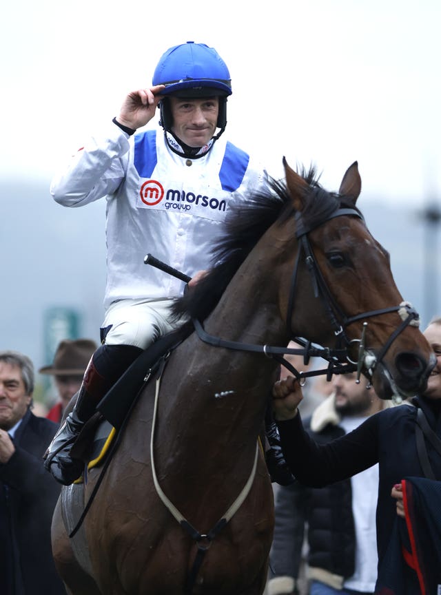 Jockey Sam Twiston-Davies salutes the crowd on his return with Potters Charm