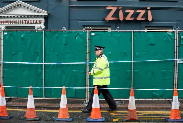 An officer passes a barrier erected by police outside the Zizzi restaurant in Salisbury near to where former Russian double agent Sergei Skripal was found critically ill (Andrew Matthews/PA)