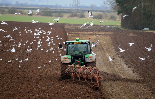 A farmer ploughs a field in North Yorkshire