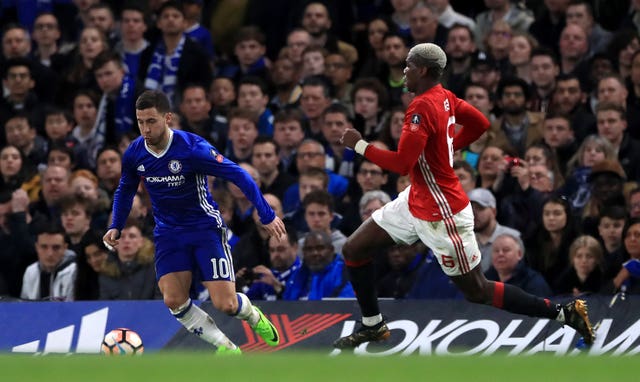 Chelsea’s Eden Hazard (left) is chased down by Manchester United’s Paul Pogba