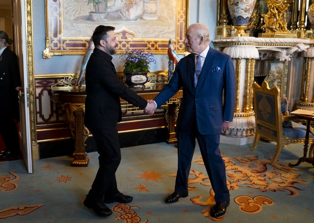 Charles shakes hands with the president 
