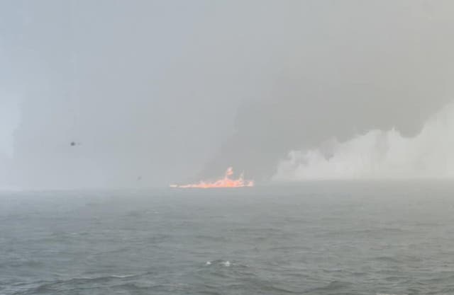 Black smoke billowing into the air after the collision