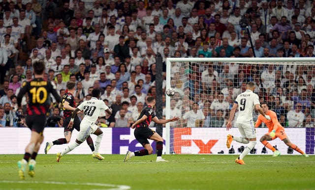Vinicius Junior, centre left, scores Real Madrid's opener against Manchester City