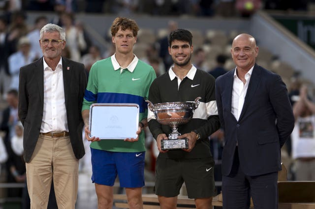 Jannik Sinner and Carlos Alcaraz pose with their trophies after the French Open final
