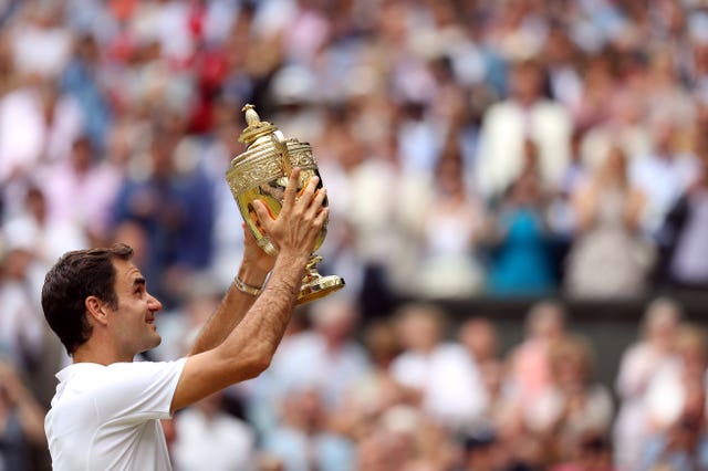 Roger Federer holds up the Wimbledon trophy for the eighth time
