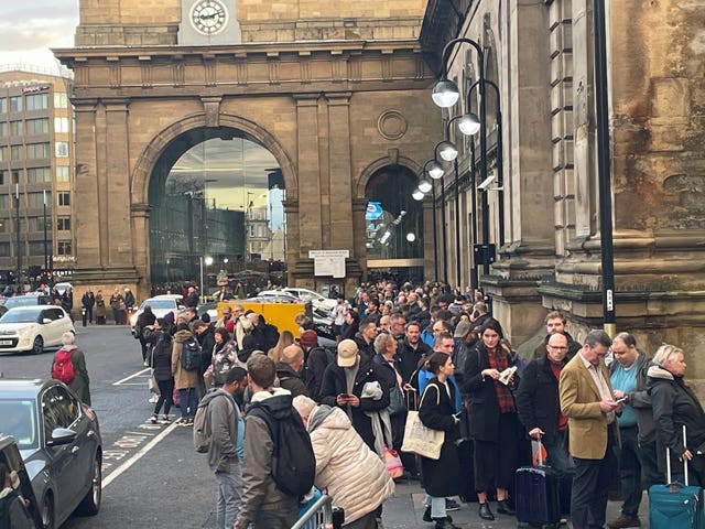 Hundreds of rail passengers queue outside Newcastle train station for replacement buses after trains to Scotland were cancelled due to flooding