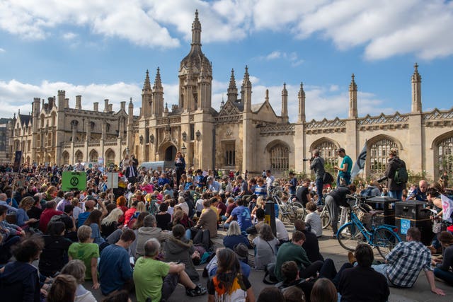 Protesters sit down in the street in front of King’s College at the UK Student Climate Network’s Global Climate Strike in Cambridge