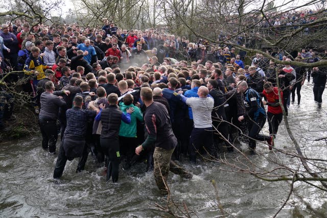 Players take part in the Royal Shrovetide Football Match in Ashbourne, Derbyshire, which has been played in the town since the 12th century 