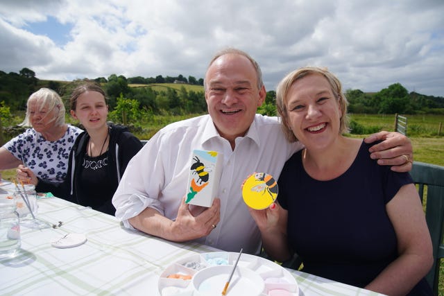 Liberal Democrat leader Sir Ed Davey showing his pottery with candidate Lisa Smart
