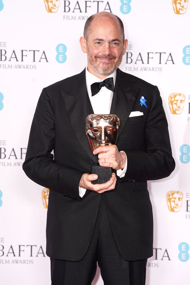 Edward Berger with the award for best director for All Quiet On The Western Front  