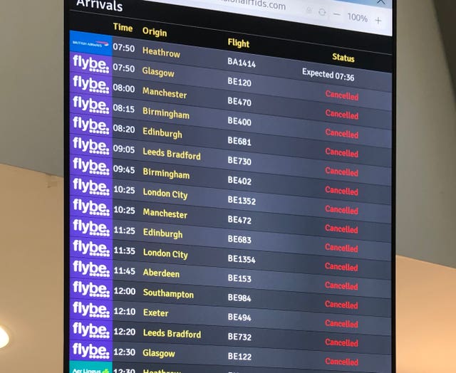 The flight departure boards showing cancelled flights at Belfast Airport