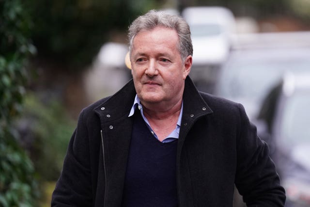 Piers Morgan walks along the street