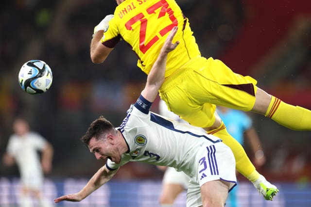 Andy Robertson collides with Spain goalkeeper Unai Simon, right