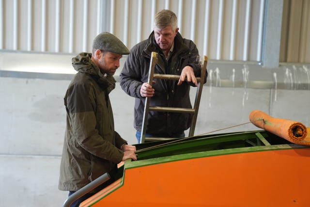 Farmer Phil Gorringe showing the Prince of Wales a seed drill machine