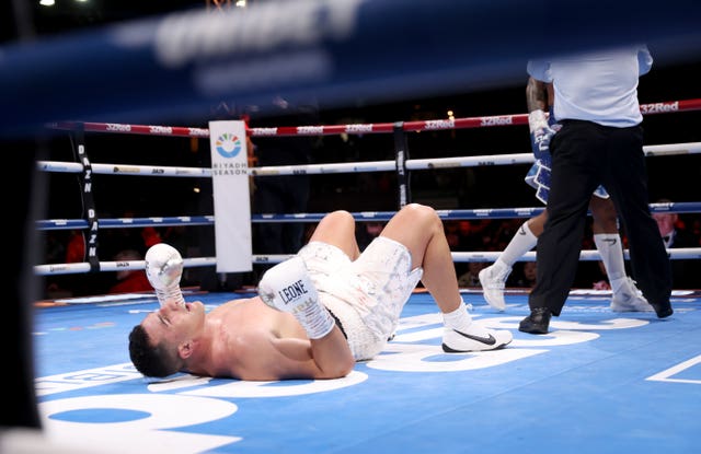 Justis Huni lies on the canvas