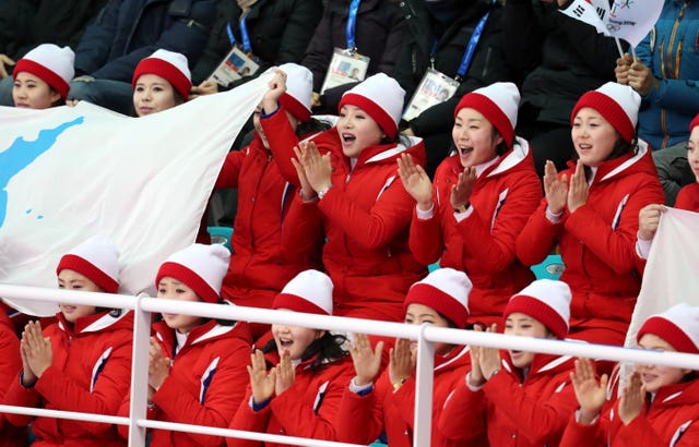 The North Korean cheerleaders watch on undaunted as a unified Korean team lost heavily in their ice hockey preliminary against Switzerland