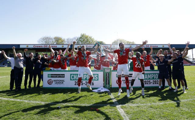 York City&rsquo;s players and staff celebrate with the trophy