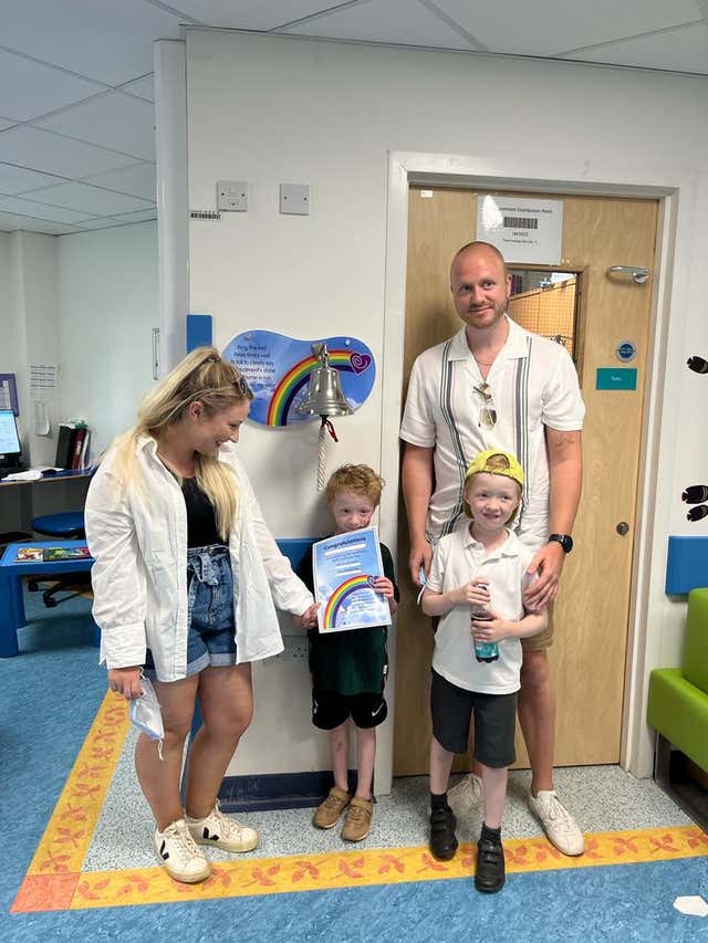 Archie Wilks with his mother Harriet, father Simon and twin brother Henry, ringing the bell at Addenbrooke’s Hospital, Cambridge, to celebrate the end of his treatment for the rare childhood cancer neuroblastoma 