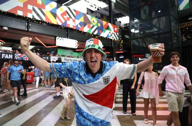 England football fan with his arms raised aloft 