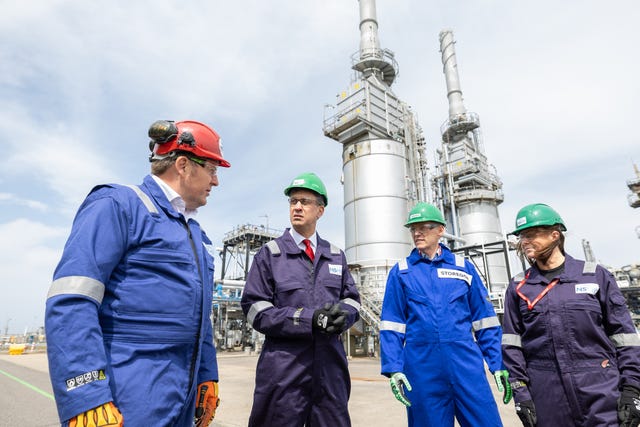Ed Miliband dressed in hard hat and boiler suit with others dressed the same