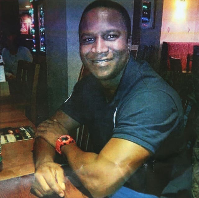 Handout photo of Sheku Bayoh smiling while sitting at a table