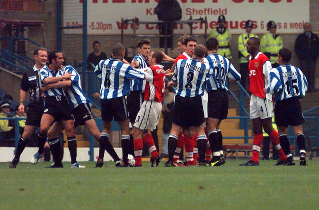 Paolo Di Canio, far left, had to be restained after an incident with Martin Keown, which saw both players dismissed