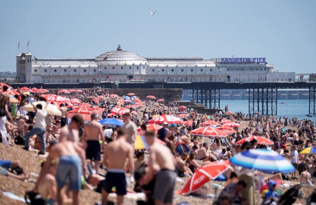 A view of the beach as people enjoy the hot weather in Brighton, East Sussex
