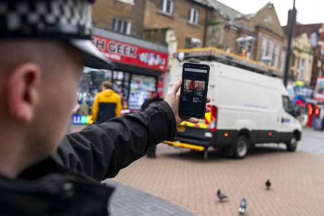 A police officer demonstrates the smart phone app used by the Met’s live facial recognition technology in Croydon