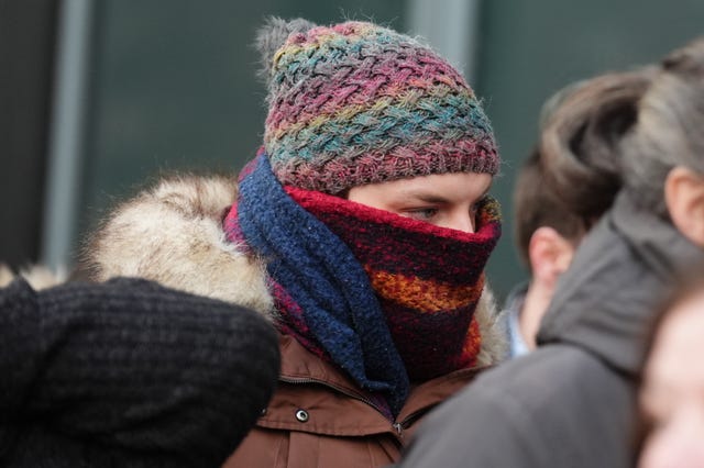 Dr Beth Upton, with a hat on and a scarf over her face