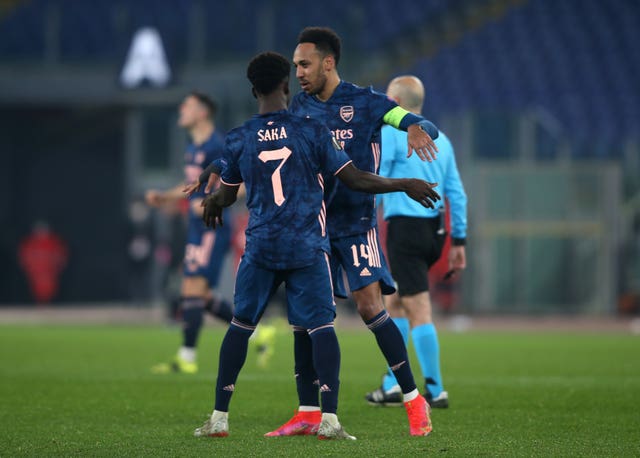 Arsenal’s Bukayo Saka (left) celebrates his equaliser against Benfica