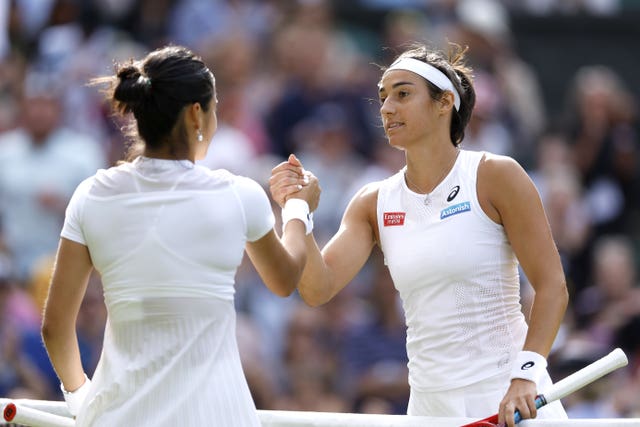 Emma Raducanu, left, and Caroline Garcia shake hands at Wimbledon