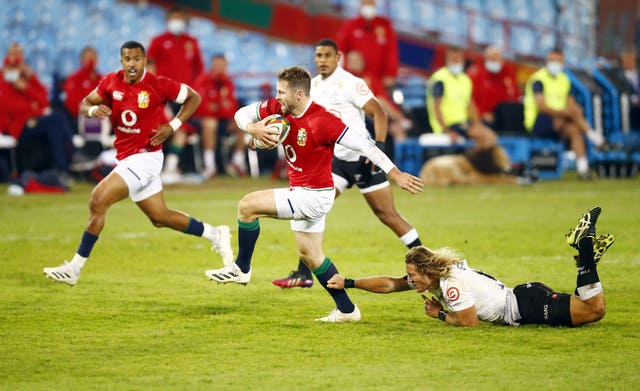 British and Irish Lions' Elliot Daly escapes a tackle from Cell C Sharks' Werner Kok 