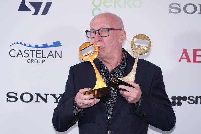 Ken Bruce with Tric two awards, kissing one