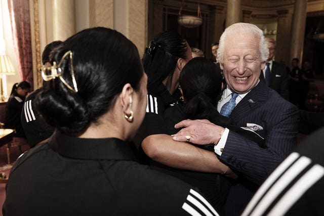 The King is hugged by New Zealand’s Black Ferns rugby union team at Buckingham Palace 