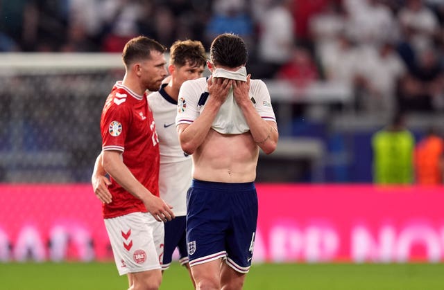 Declan Rice covers his face with his shirt after the final whistle of the draw with Denmark