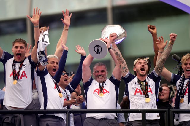 Tottenham manager Ange Postecoglou (centre) with the trophy on stage during the Europa League winners parade