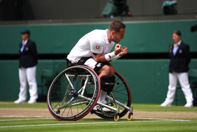 Alfie Hewett crouches forward and clenches his fists in celebration