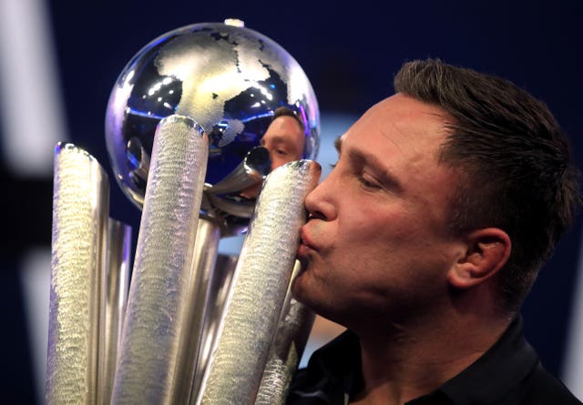 Gerwyn Price kisses the trophy after winning the William Hill World Darts Championship