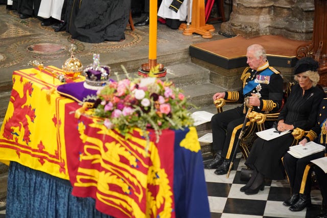 King Charles III and the Queen Consort in front of the Queen's coffin