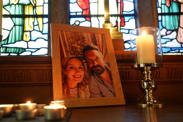 Candles are lit around a photo of Nicola Bulley and her partner Paul Ansell on an altar at St Michael’s Church in St Michael’s on Wyre, Lancashire (PA)