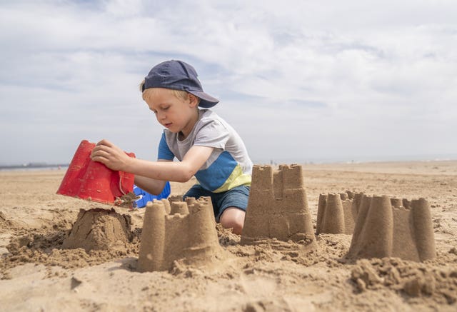 A young boy building sandcastles on Bridlington beach