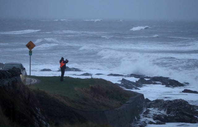 A man photographs waves cause by storm Deirdre in Balbriggan