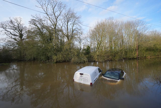 Vehicles left abandoned in a flooded ford in Leicestershire