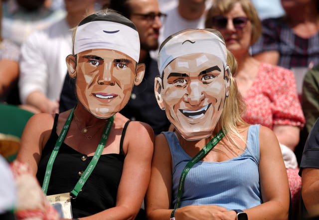 Spectators wearing Roger Federer and Rafael Nadal masks