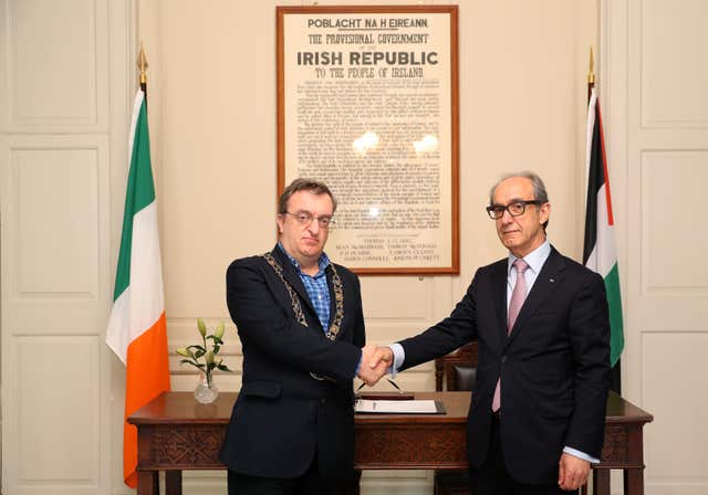 Micheal Mac Donncha and Ahmad Abdelrazek launch the book of condolence at Mansion House