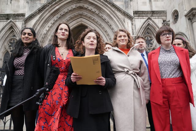 A group of women standing outside the Royal Courts of Justice