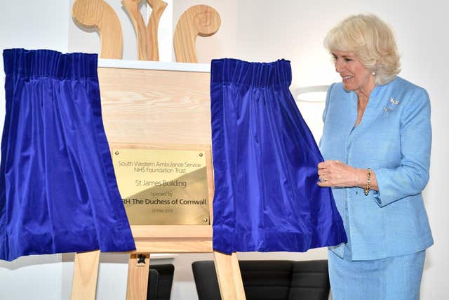 The Duchess of Cornwall (left) unveils a plaque during an official visit to open the South Western Ambulance Service (SWASFT) 999 Control Hub in Bradley Stoke (Ben Birchall/PA)