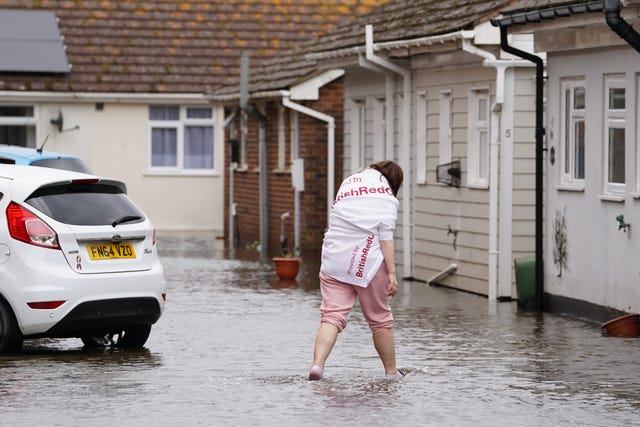A Sussex resident wading through flood water