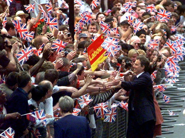 Tony Blair pictured in 1997, greeting hundreds of UK flag-waving supporters