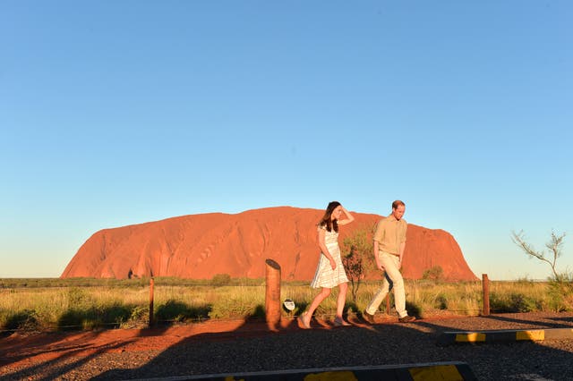 The Duke and Duchess of Cambridge pose for media with Uluru in the background during the 16th day of their official tour to New Zealand and Australia in 2014